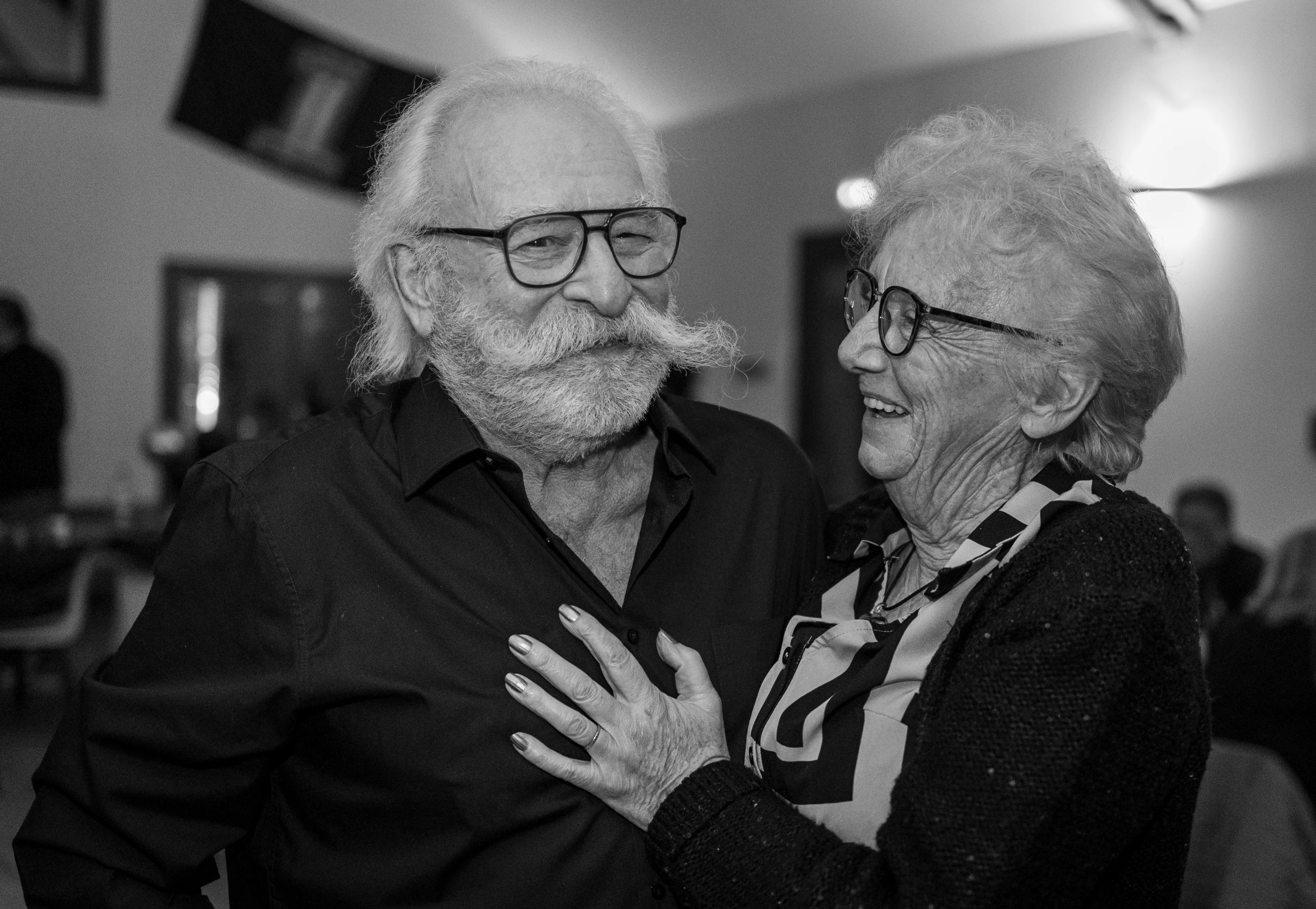 Portrait en noir et blanc d'un couple amoureux âgé s'anlaçant photographié lors d'un anniversaire par Marine Bourely Photographe